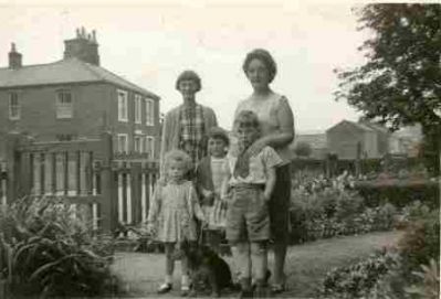Outside 6 Nelson Square.
"Me (the one with Churly Hair) Rosemary Ward, Gregory Ward, \
Behind: Mary Wilson and Mam (Rose Ward nee Brocklebank)\
Also Whiskey the dog belonged to Alice Haile next door."

